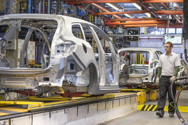 New production line for the assembly of cars with modern equipment and senior mechanical engineer.